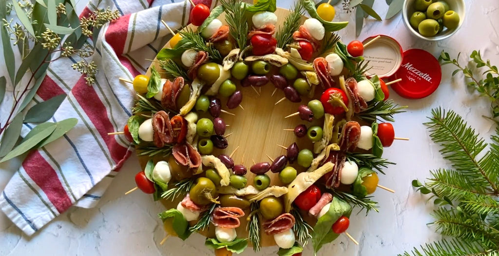 A charcuterie board with antipasto skewers arranged to look like a wreath